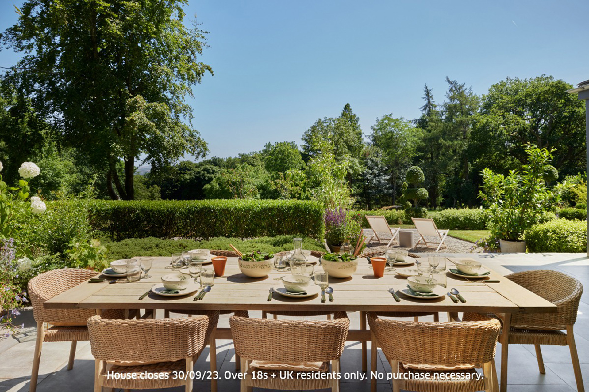 Al fresco dining area with landscaped gardens beyond