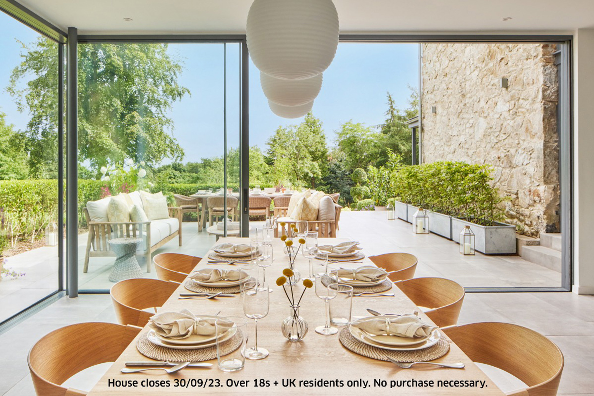 Modern dining room with floor-to-ceiling windows and wooden chairs