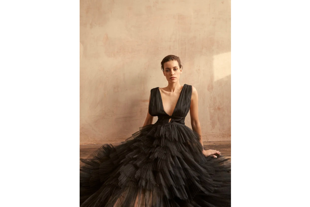 Woman sat down in black wedding dress