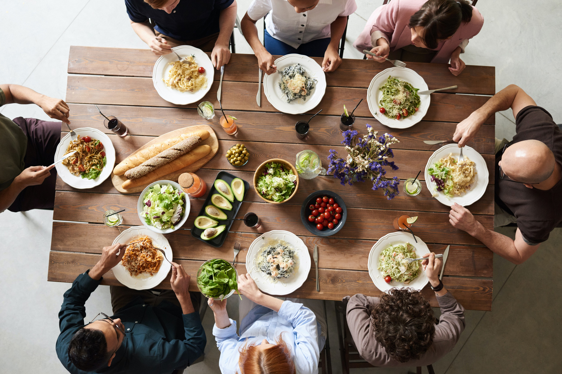 Group of friends having dinner around a table