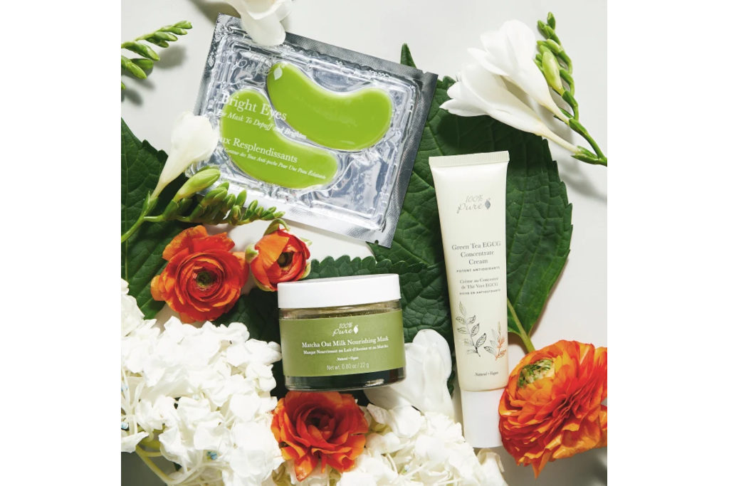 Eye masks, skin creams on floral background