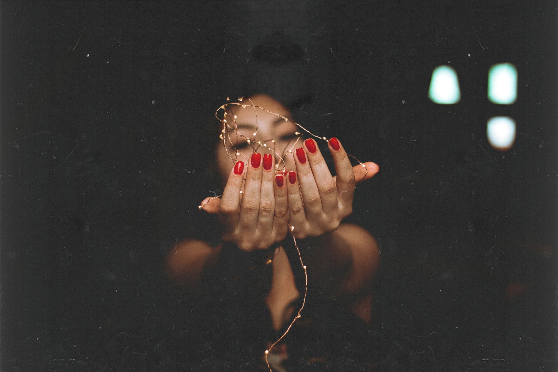 Close up of woman with red nails