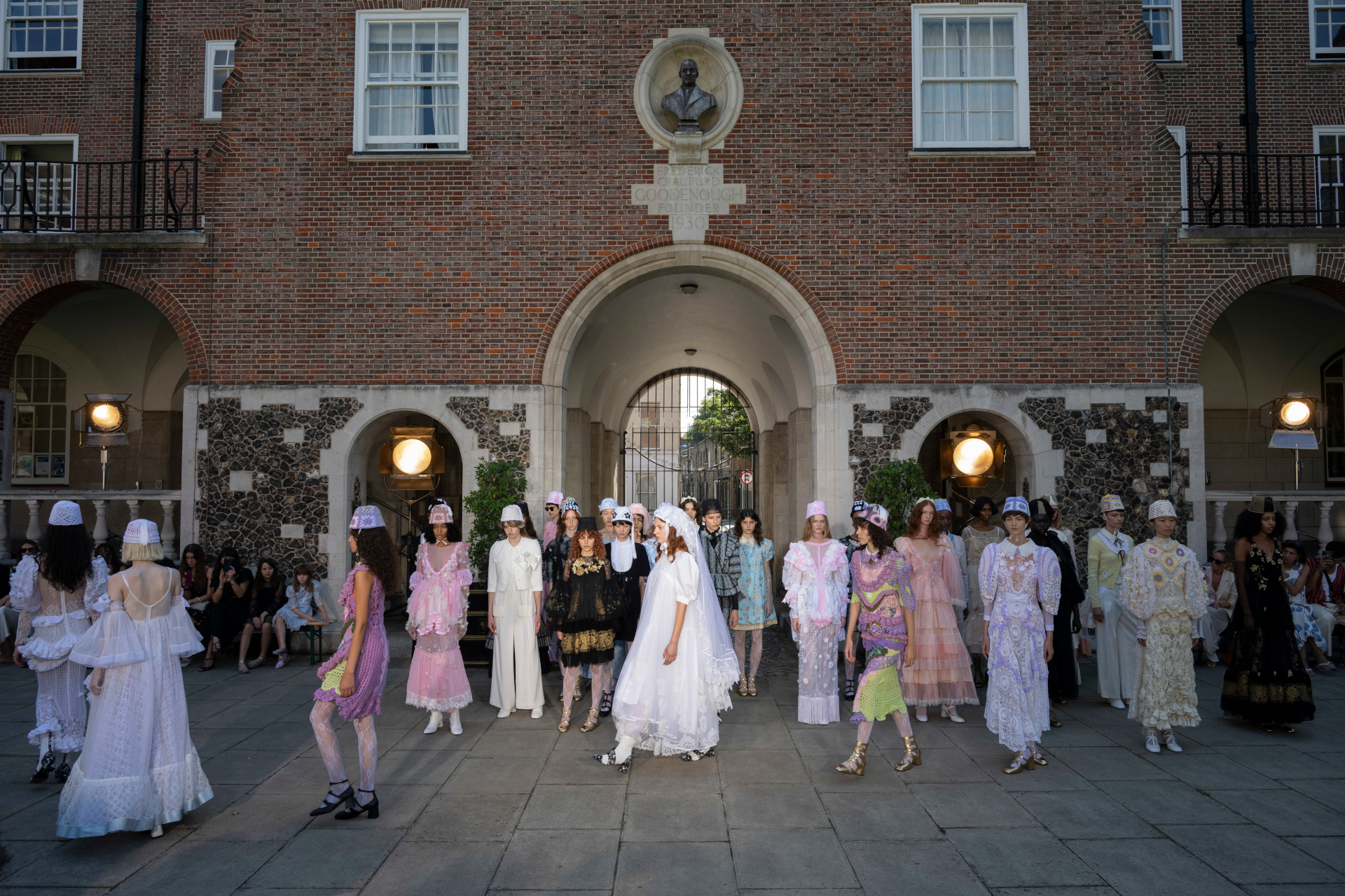 Models walking around courtyard at fashion week