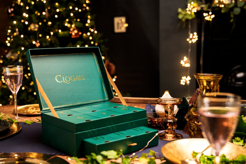 Green advent calendar surrounded by lights and set table