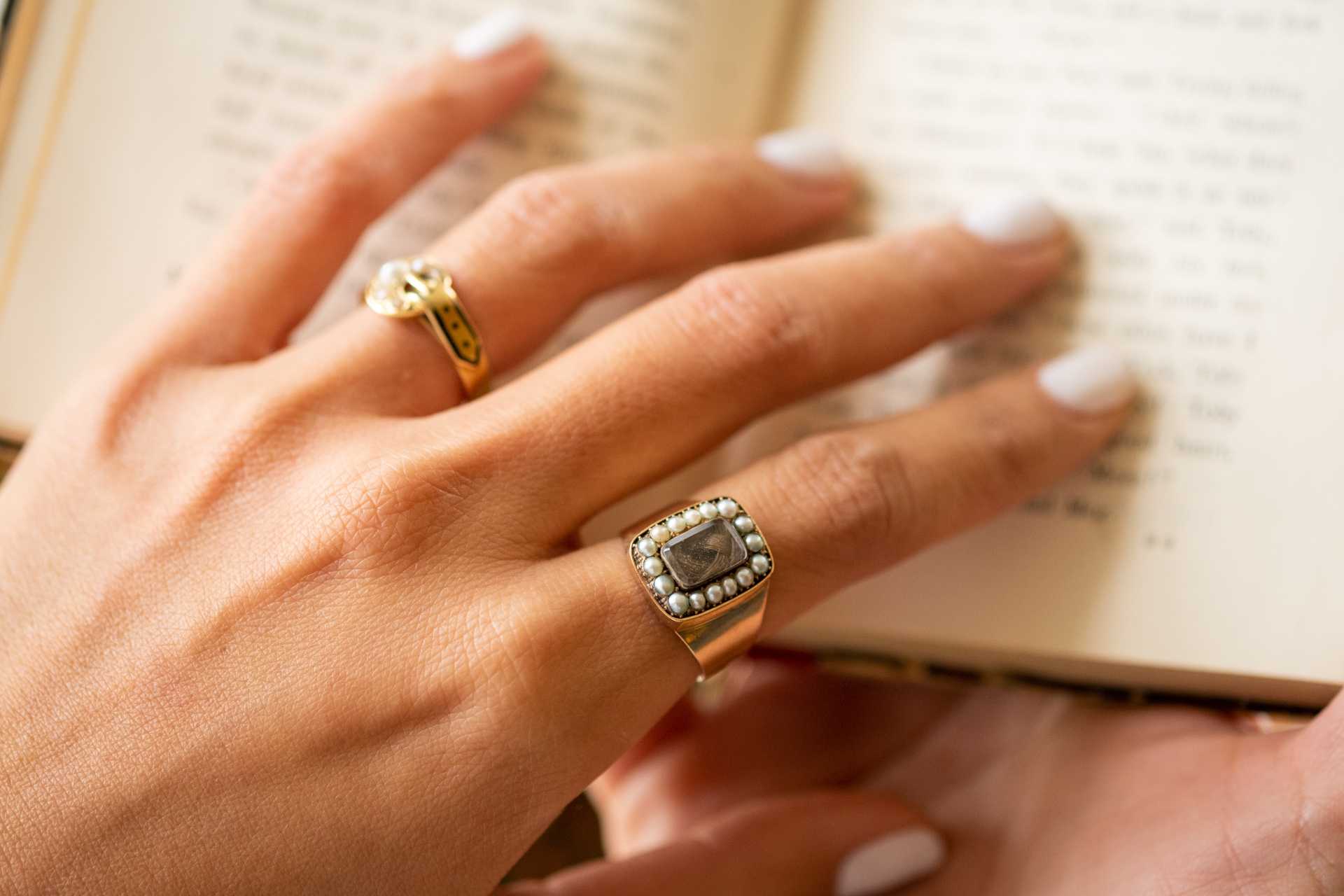 Close up of hand wearing antique rings