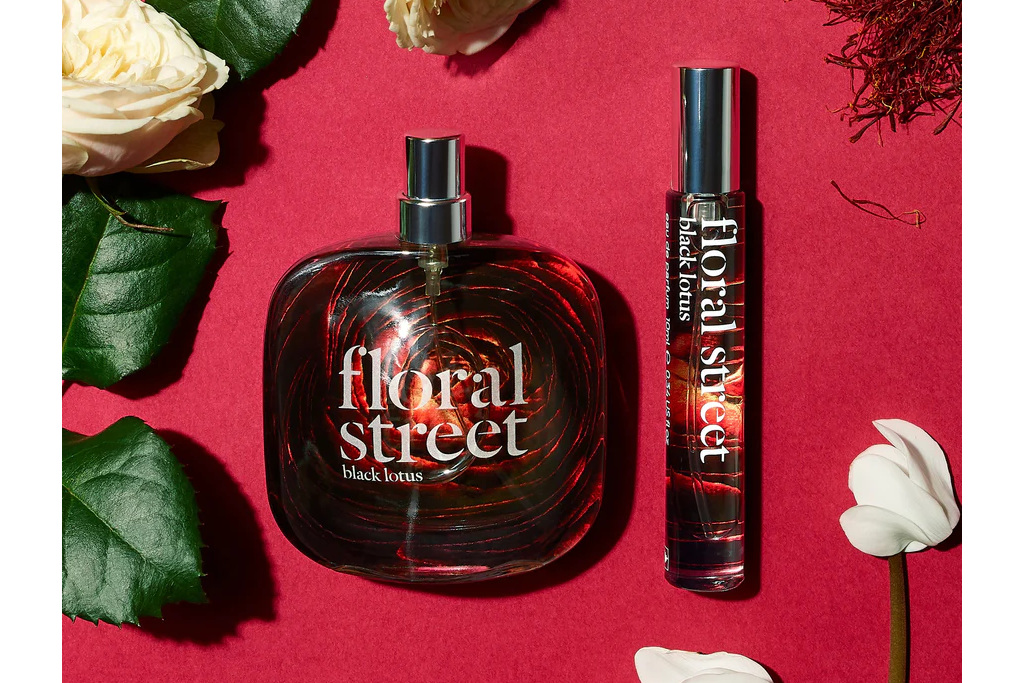Dark perfume bottle on red background