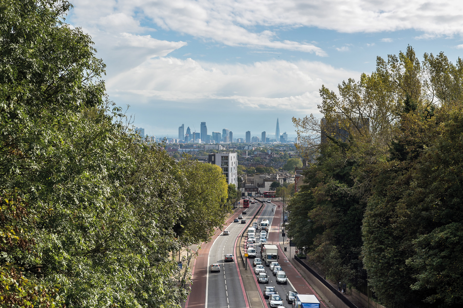 Cars on the motorway with the city in the distance.