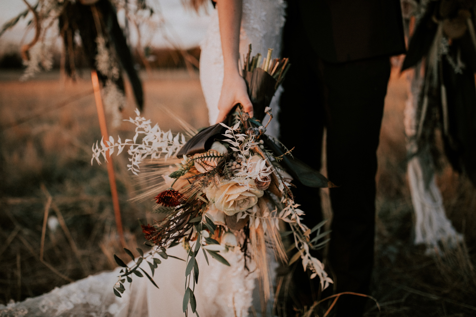 Close up of bride holding bouquet at her side