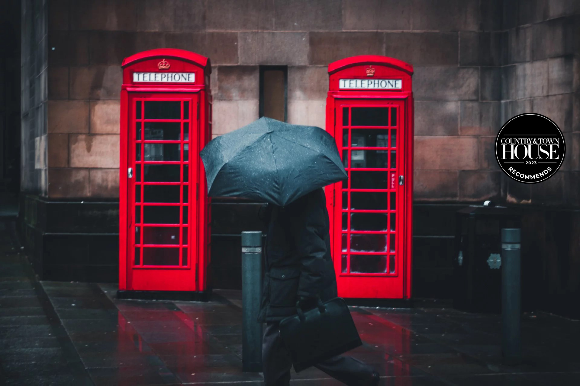 A man walking along in the rain with an umbrella