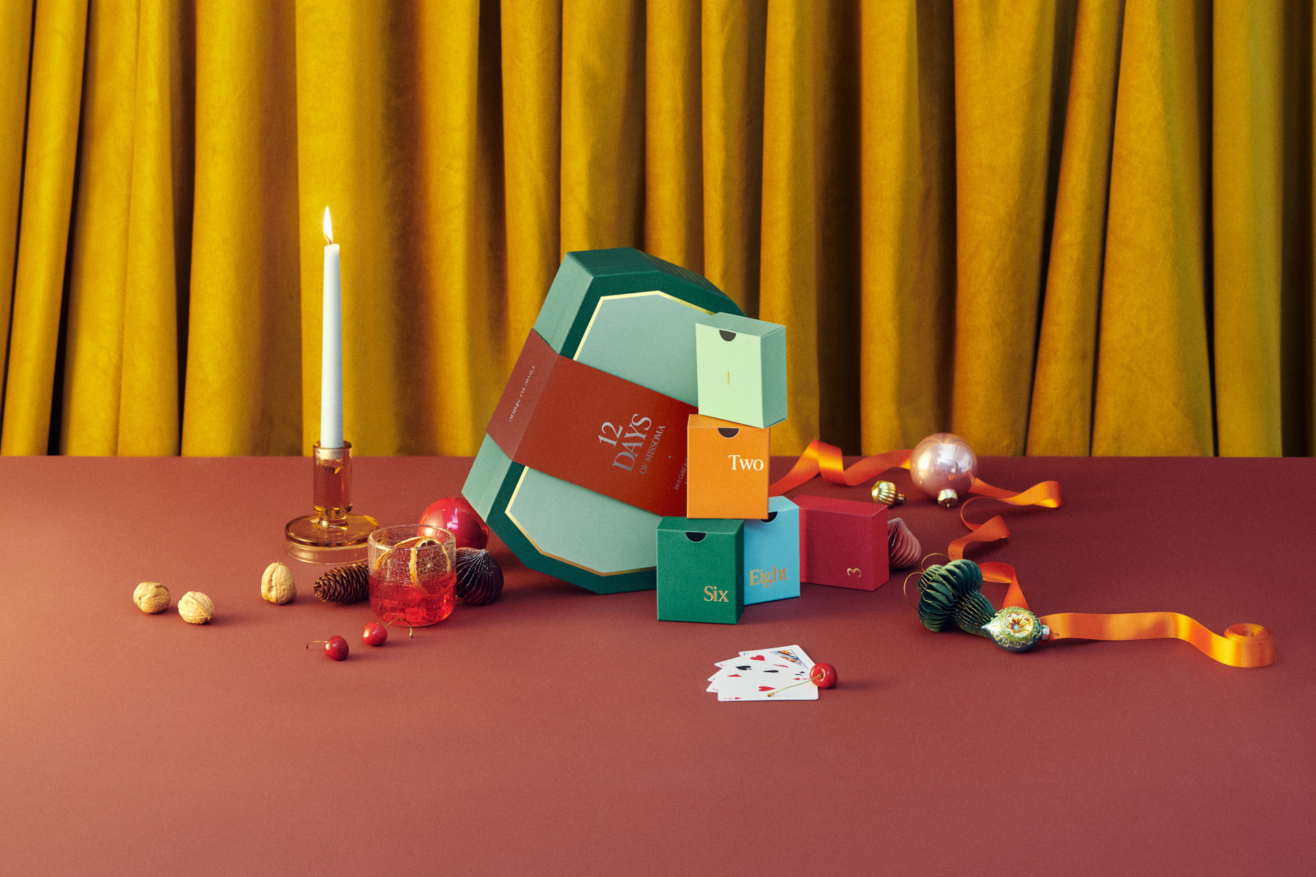 Colourful advent calendar in front of gold curtain