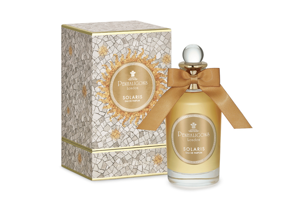 Gold perfume bottle next to box