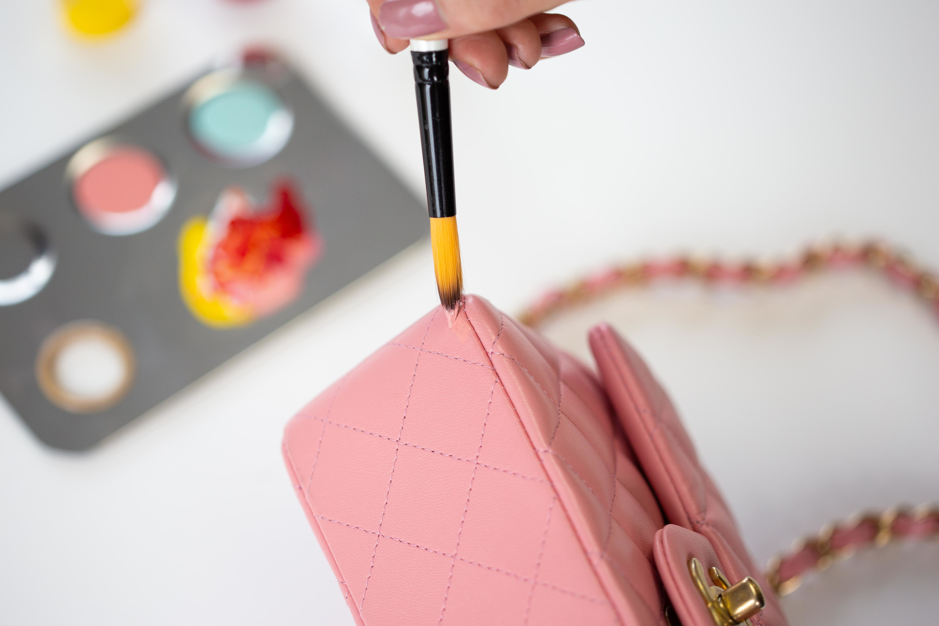 Pink handbag getting touched up