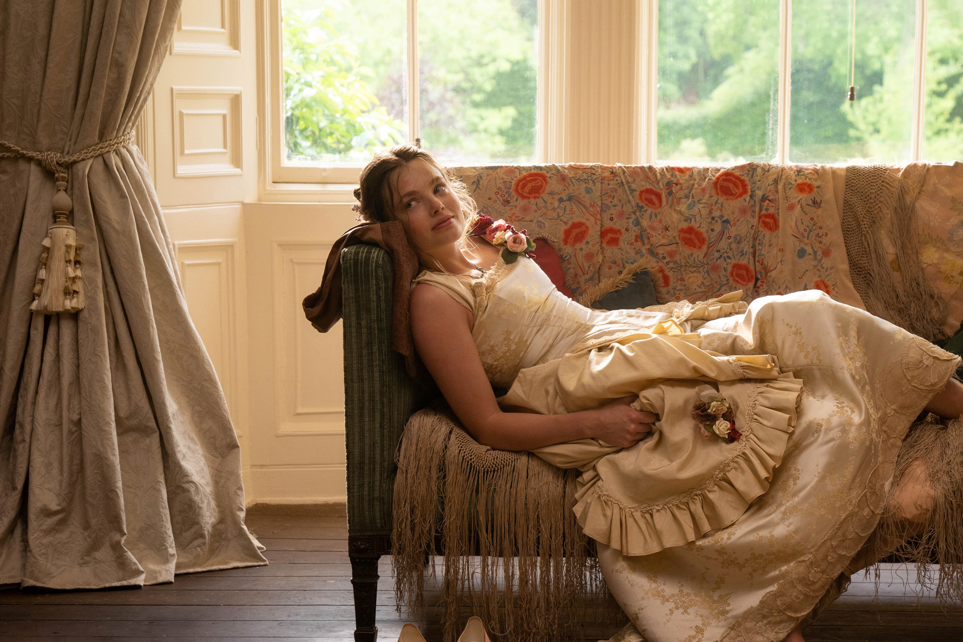 Girl in Regency costume reclining by window