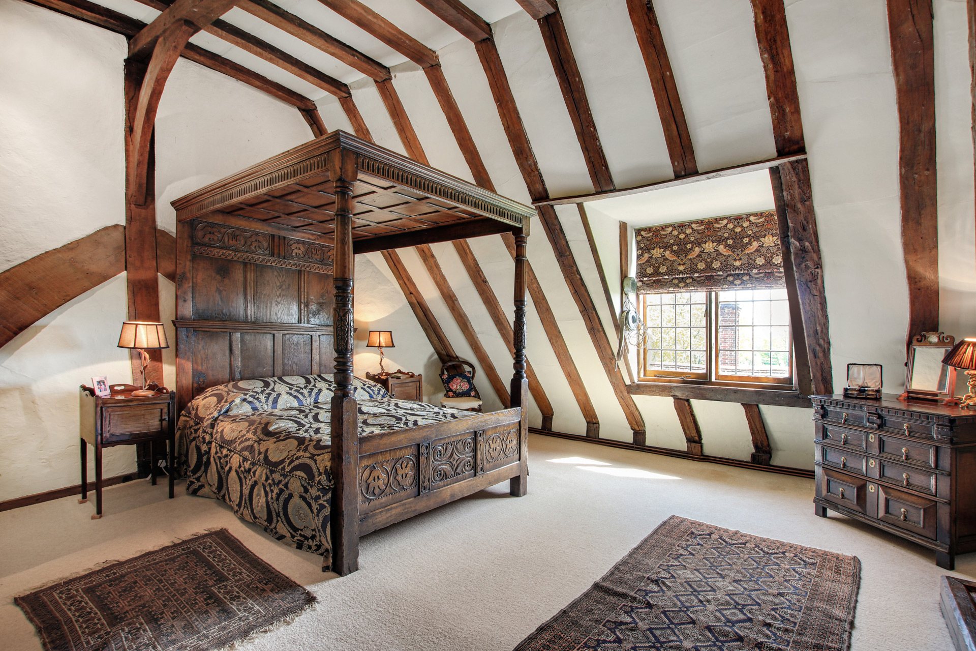 Bedroom with beams and wooden four poster bed