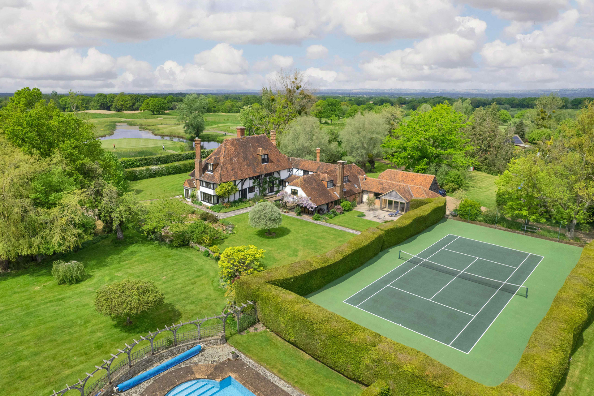 Aerial view of country estate with tennis court and pool