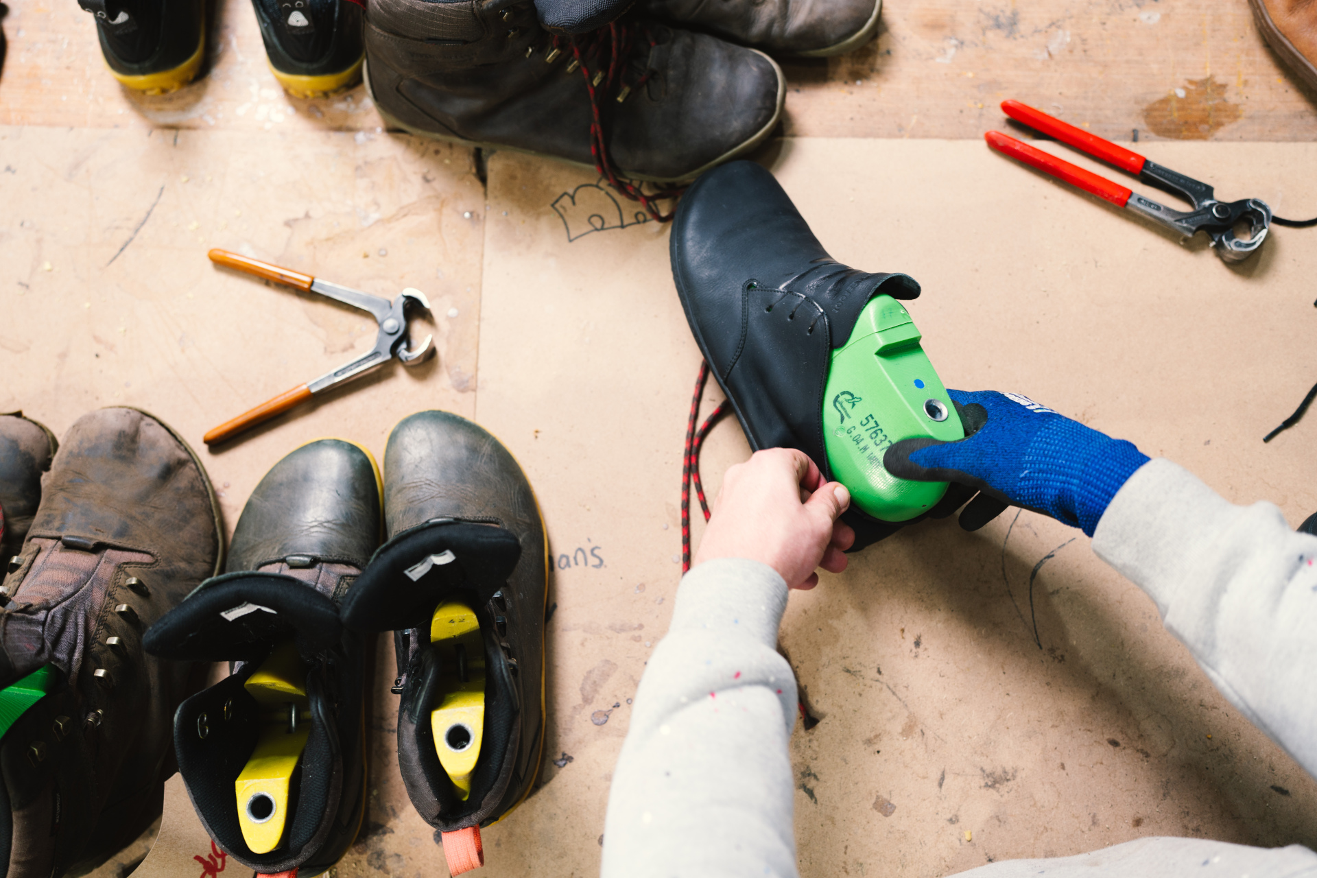 Overhead view of shoes being shaped in workshop