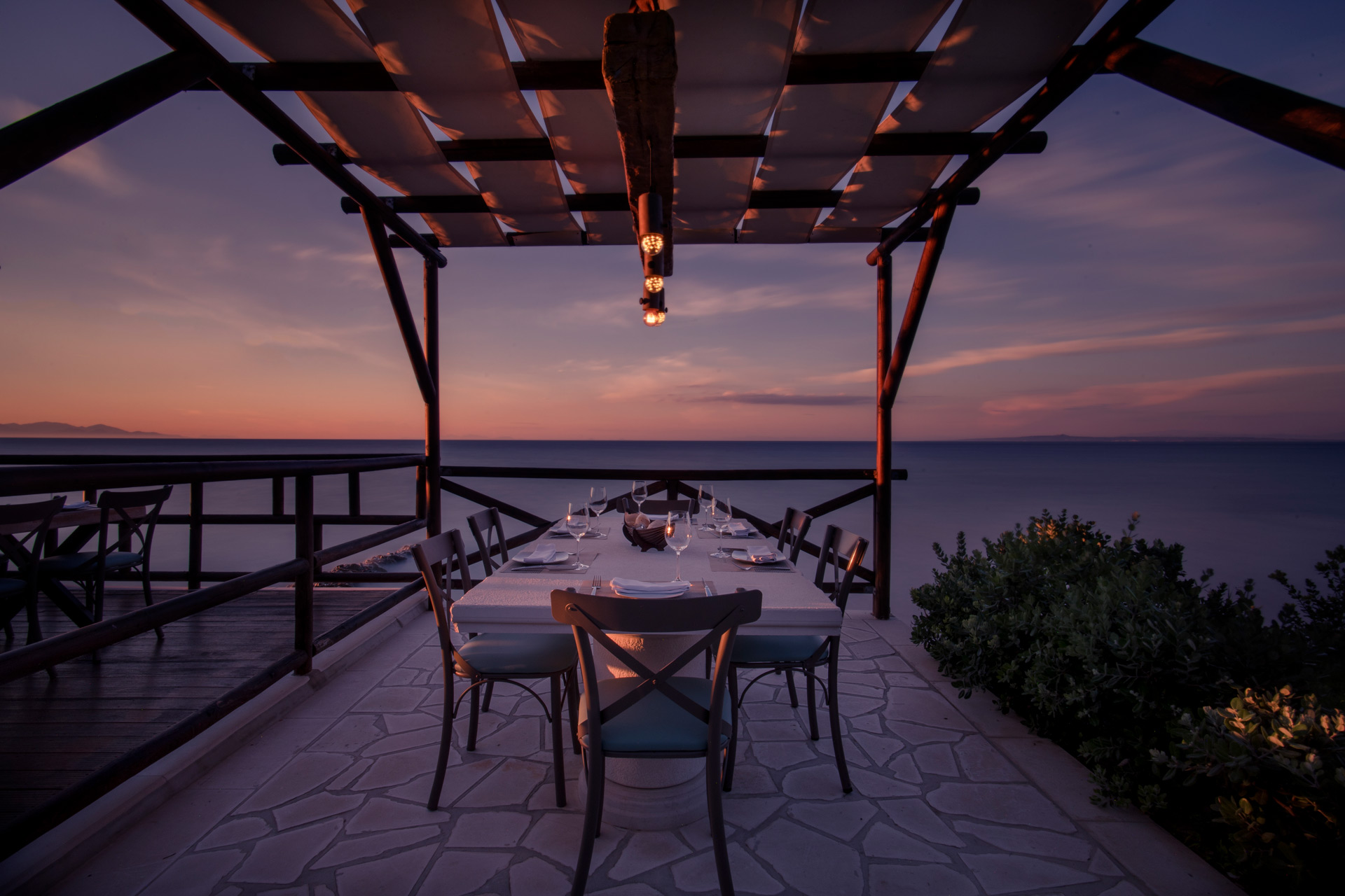 Outdoor dining at sunset at Windmill Bay Hotel