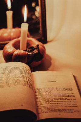 An open book with a halloween candle