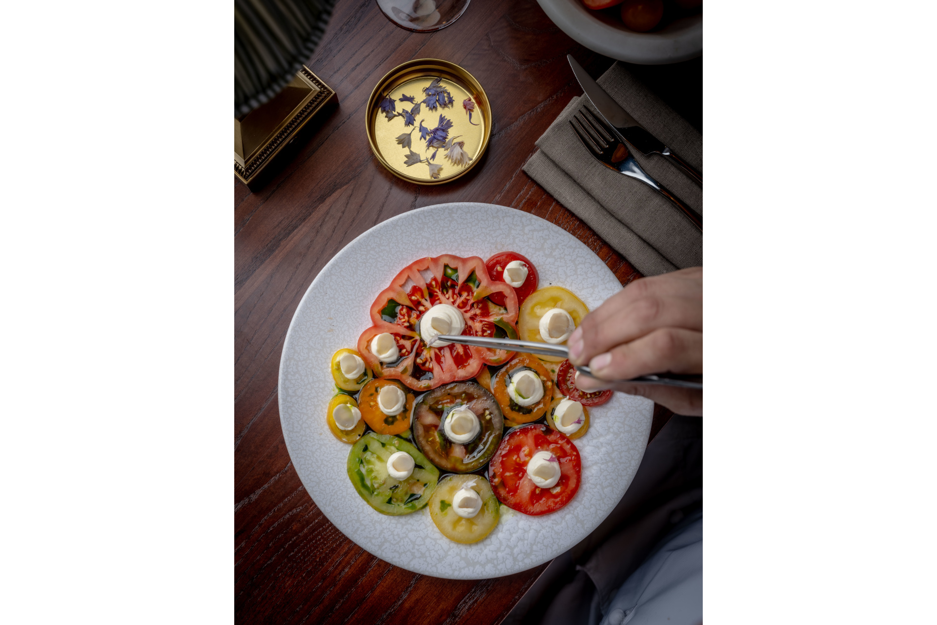 Dish of tomato slices being prepared