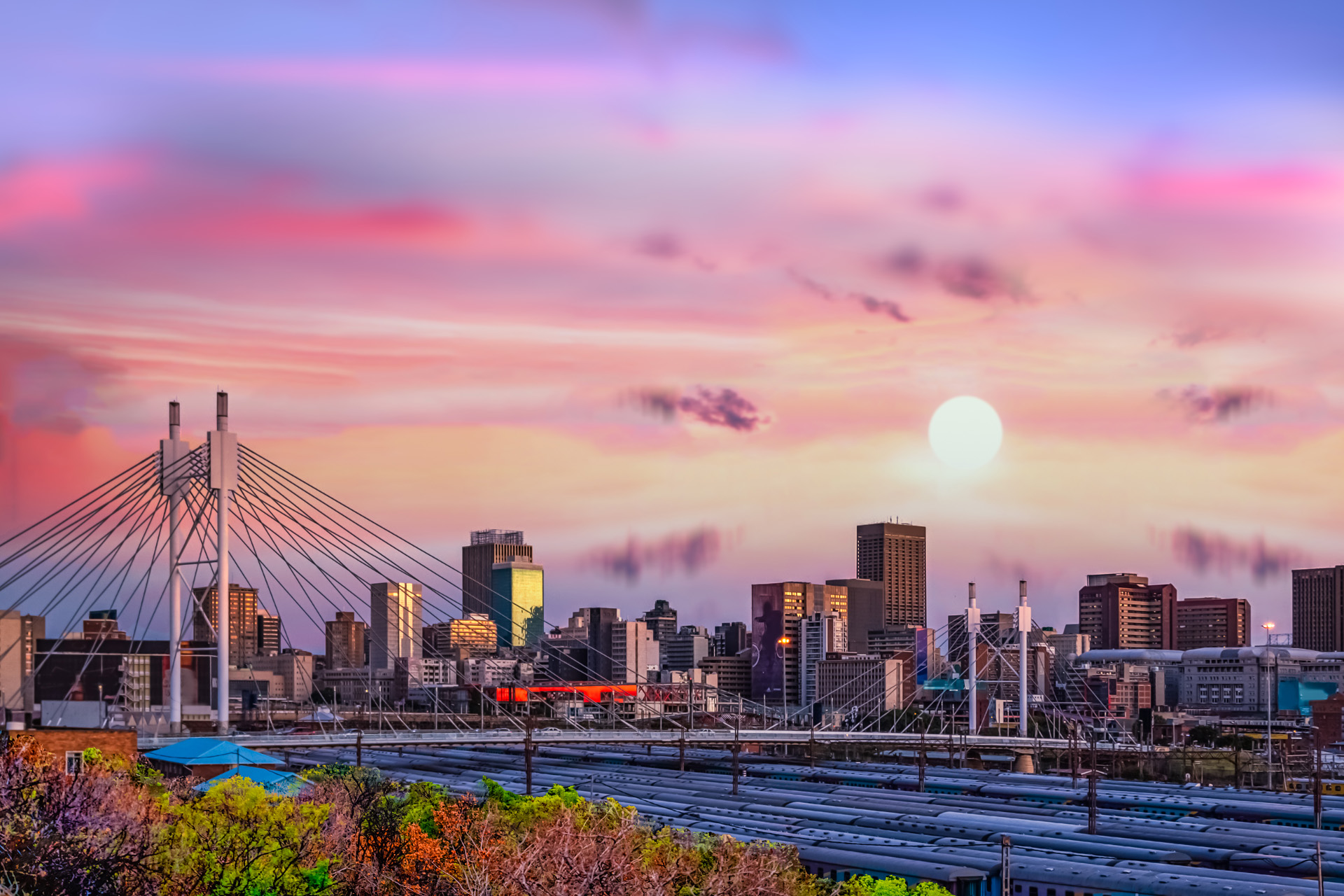 Long exposure shot of Johannesburg city skyline and Nelson Mandela bridge at sunset