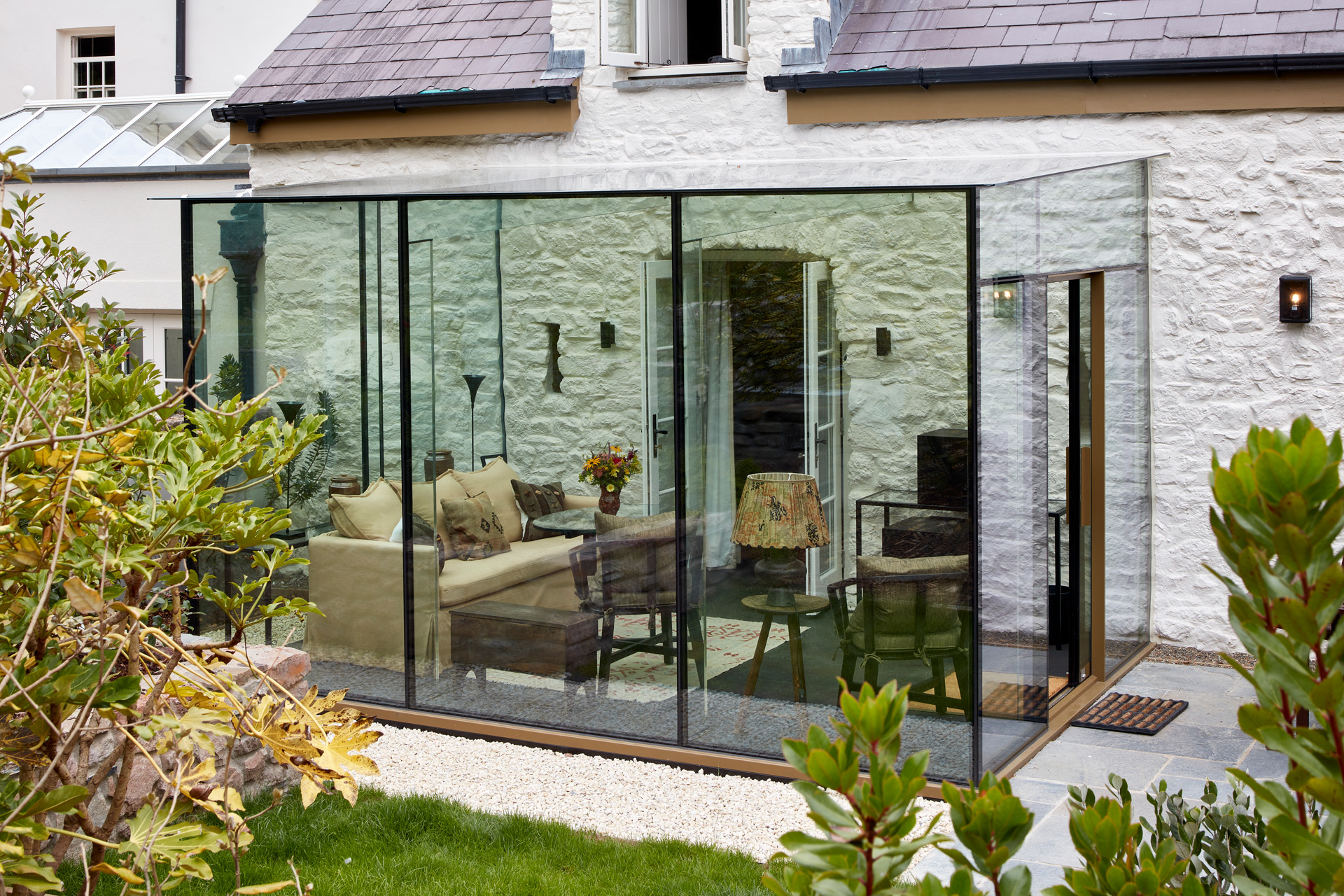 Conservatory with beige sofa and wooden furniture