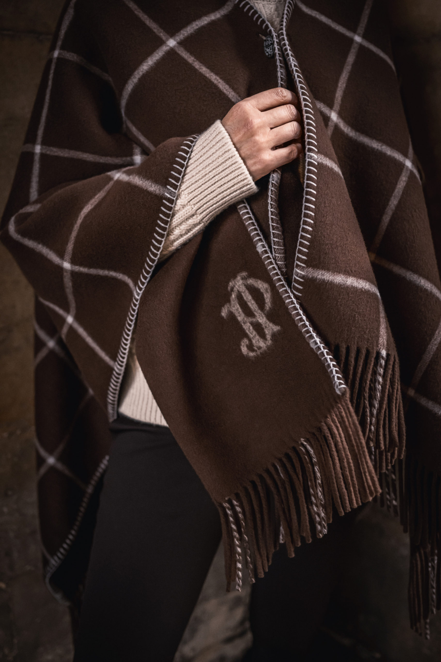 Close up of JP monogram on scarf