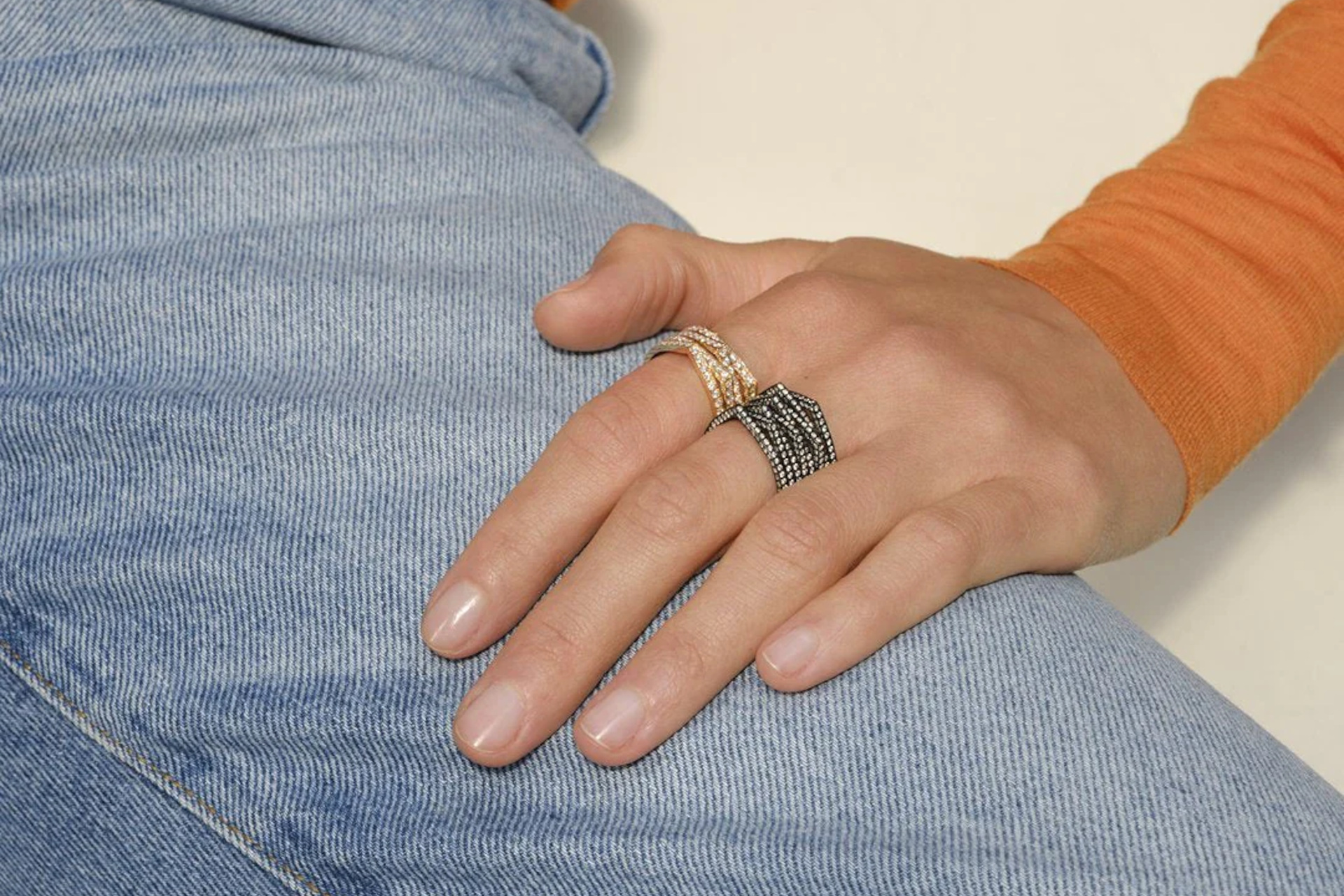 Close up of hand with gold and black rings