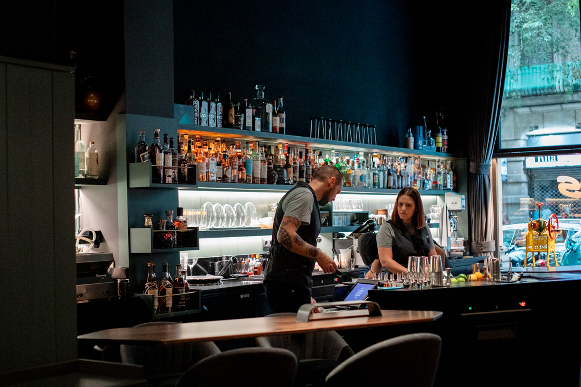 Two bartenders behind the bar at Sips in Barcelona