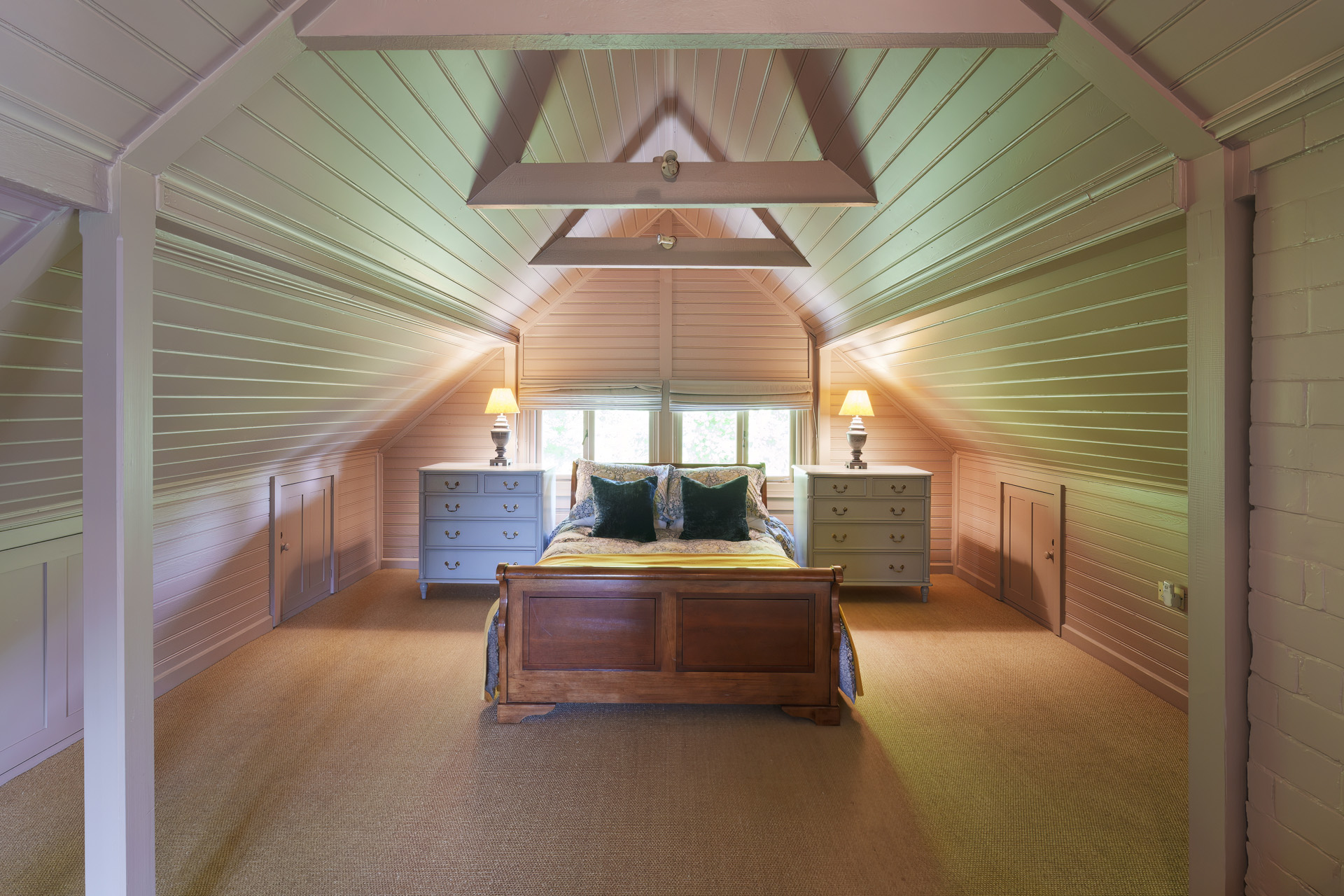 A bedroom with vaulted ceilings