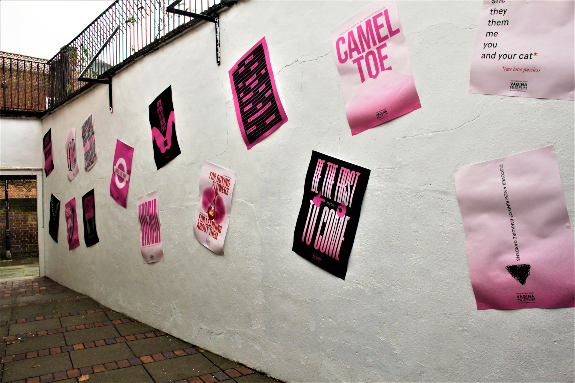Wall plastered with pink posters