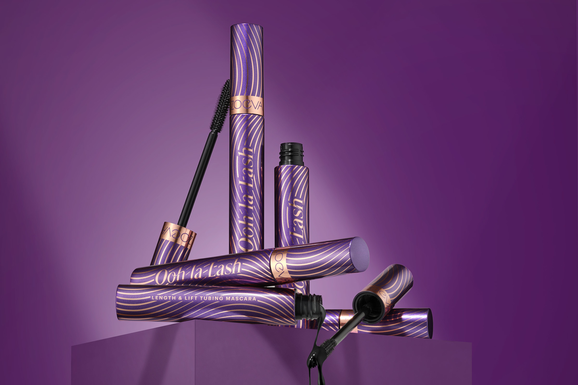 Purple mascara wands on purple background