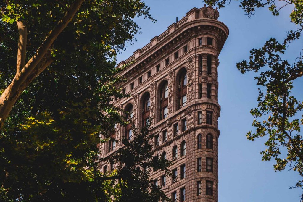 The Flatiron Building, with trees surrounding it