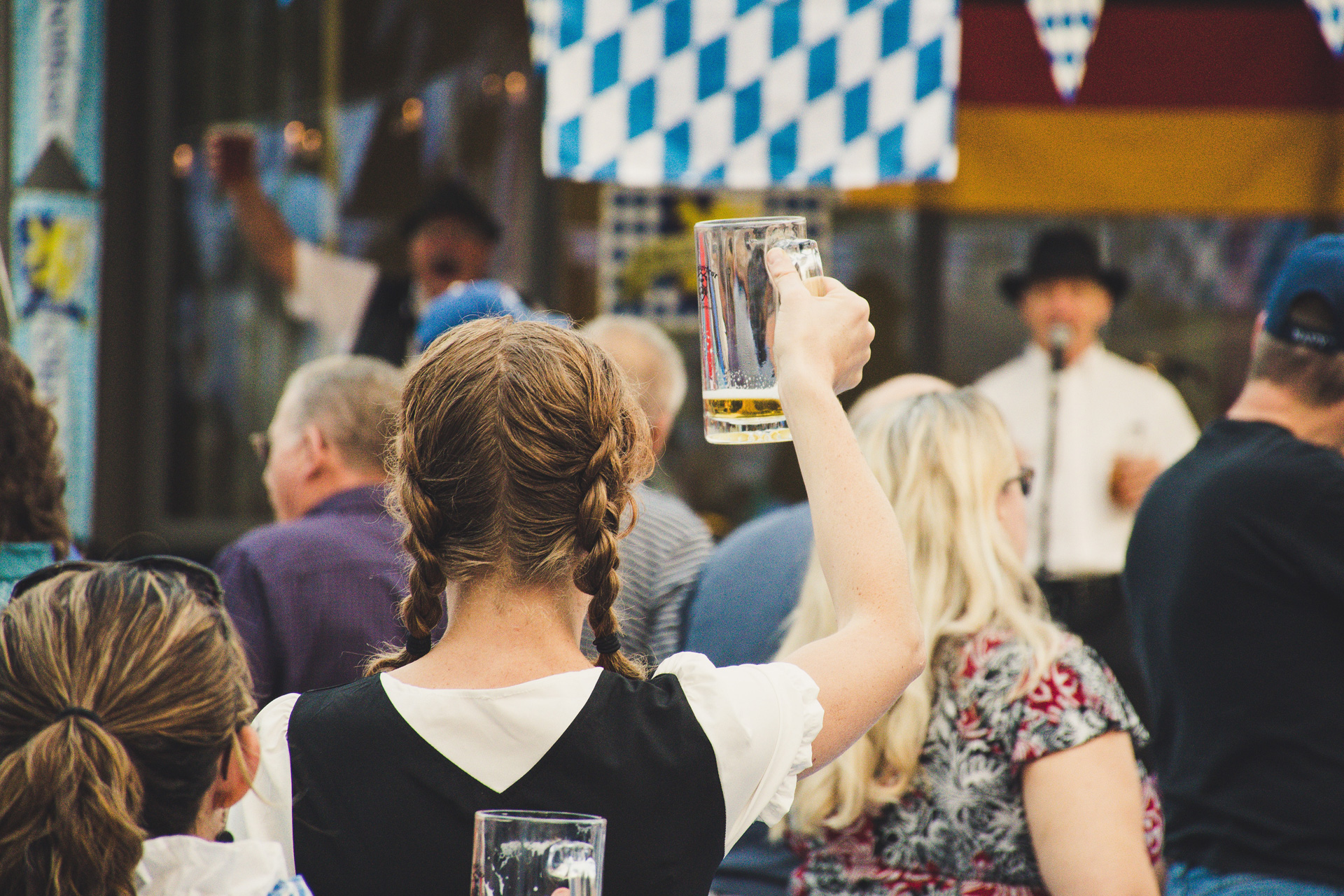 Woman holding up a beer at Oktoberfest