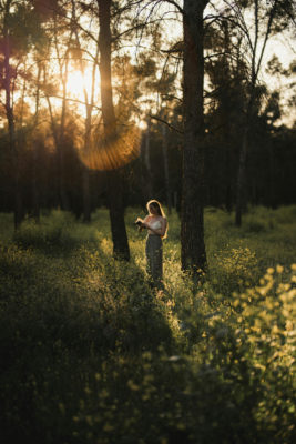 A girl reading a book in a meadow