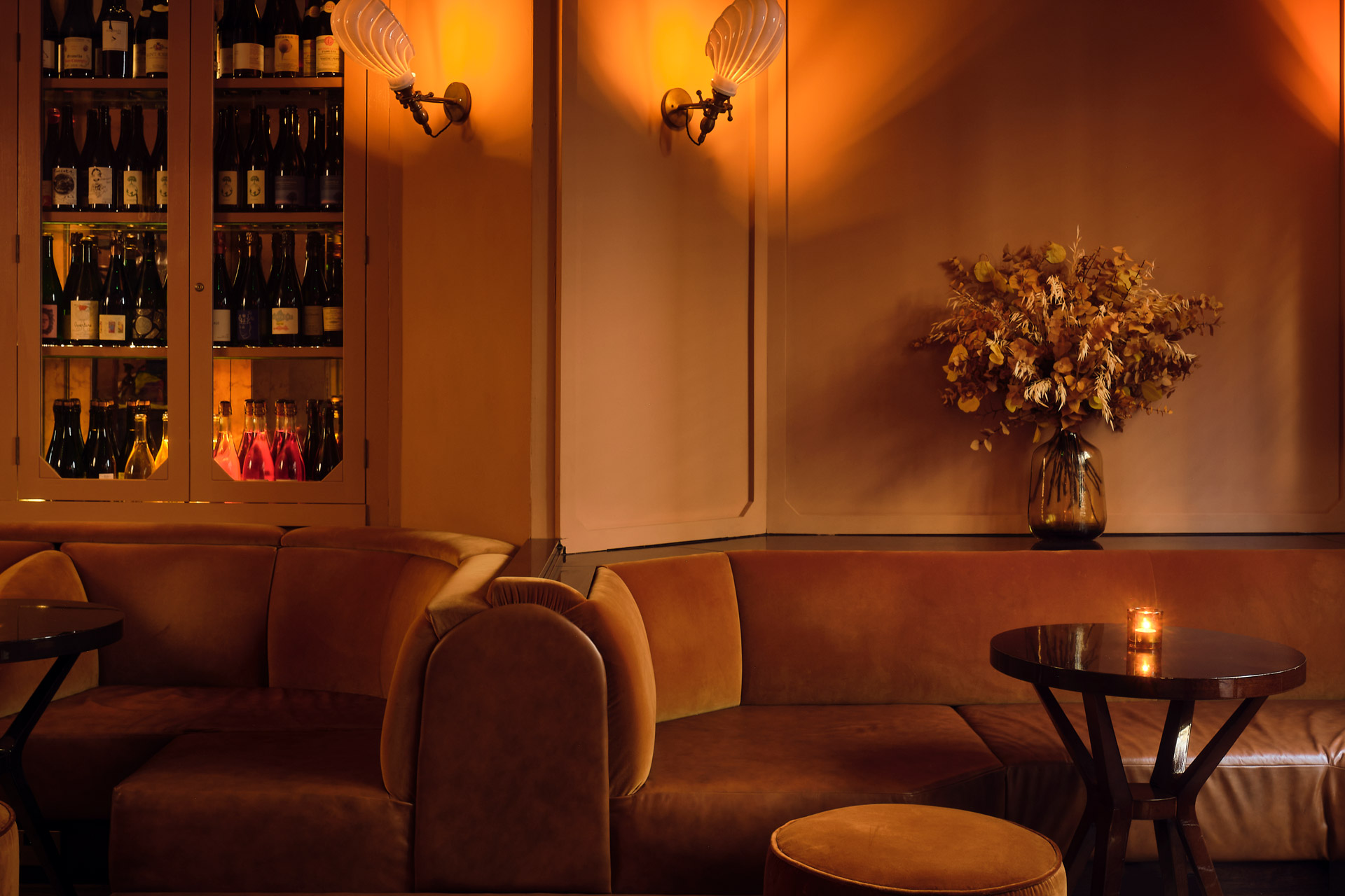 Sofa and candlelit table at The Mulwray, a wine bar in London