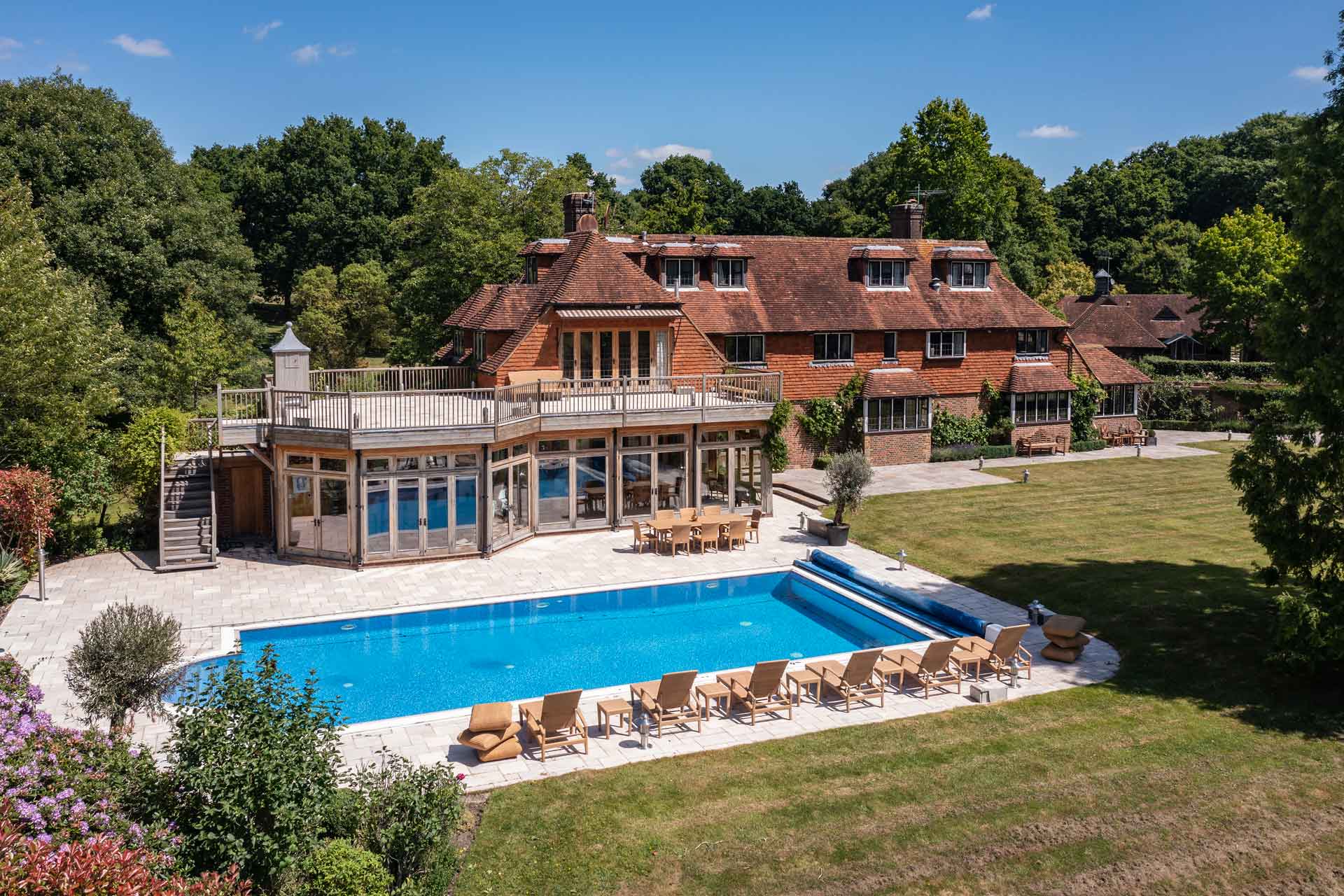 Exterior of red brick country home with outdoor pool
