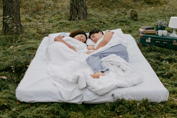 Couple in bed together outdoors