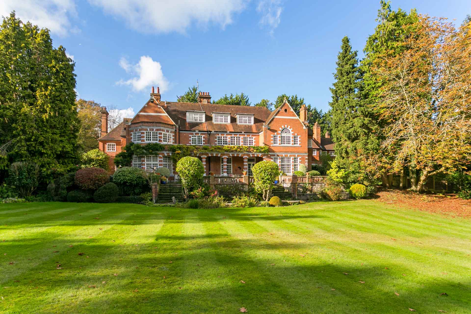 Red brick country home with lawn