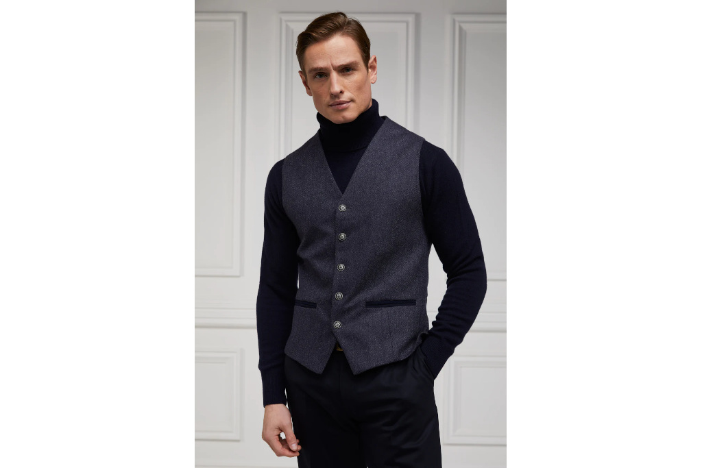 Man in black turtleneck and grey waistcoat