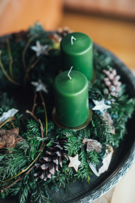 Green candles surrounded by wreath | Green Friday