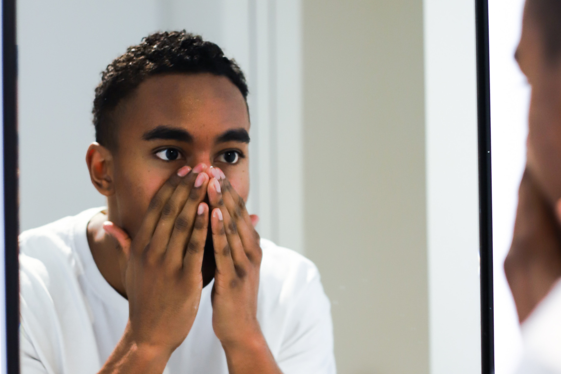 Man washing face in mirror