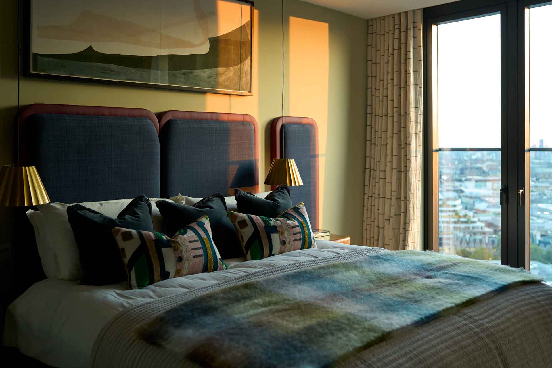 Bedroom with navy accents and floor-to-ceiling windows