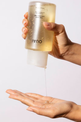 Hands pouring shampoo