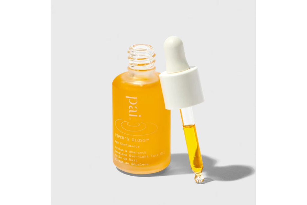 Orange serum bottle on grey background