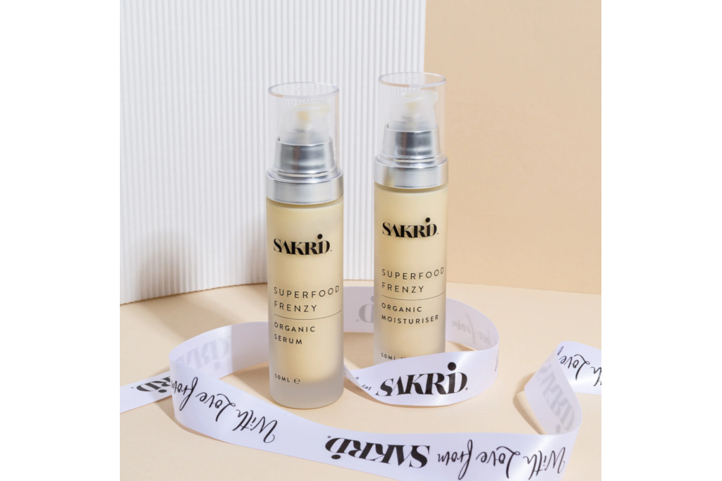 Beige serum bottles surrounded by ribbons and beige background