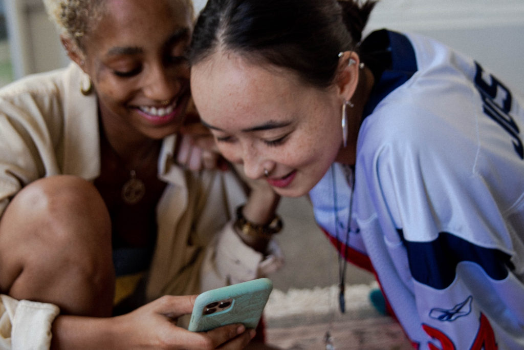 Women looking at phone - TikTok fashion competition