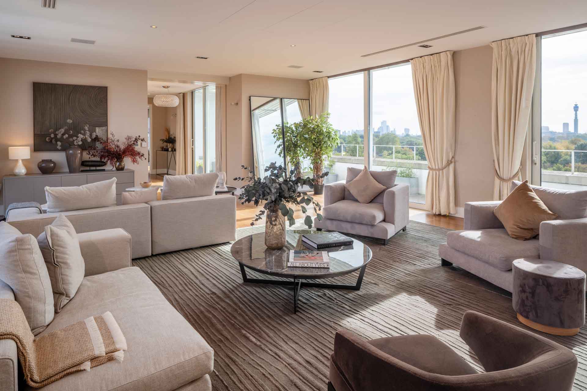 Living room with taupe furniture and floor-to-ceiling windows overlooking Regent's Park