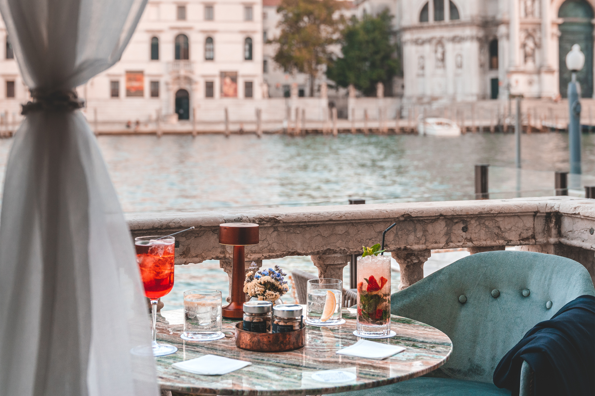 Table on balcony overlooking Venetian canal