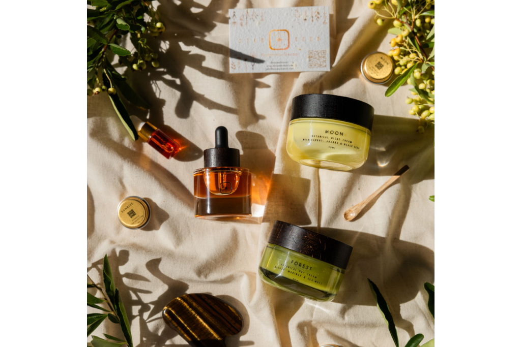 Skincare products on sheet with plants