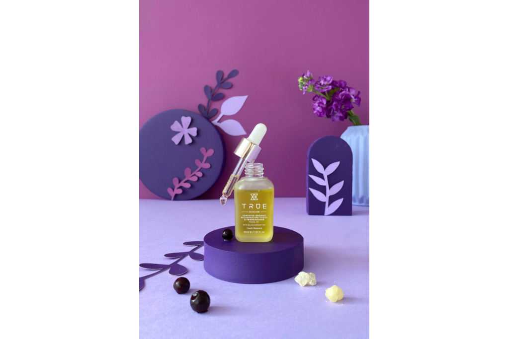 Serum bottle on purple background
